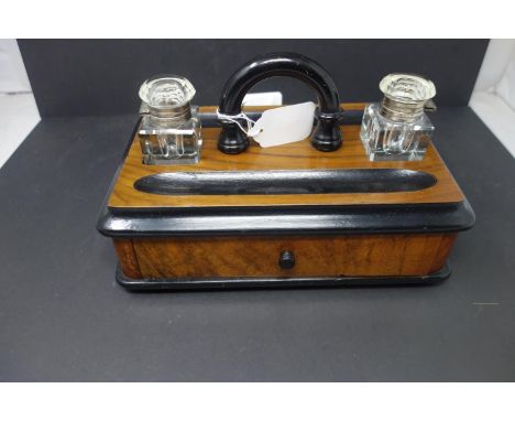 A 20th century desk stand inkwell, with two glass inkwells above single drawer, on bun feet, H.18 W.28 D.17cm 