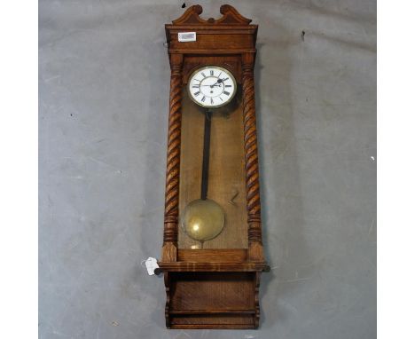 A 19th century Vienna regulator, white enamel dial with Roman numerals, with glazed door having twin barley twist pilasters, 