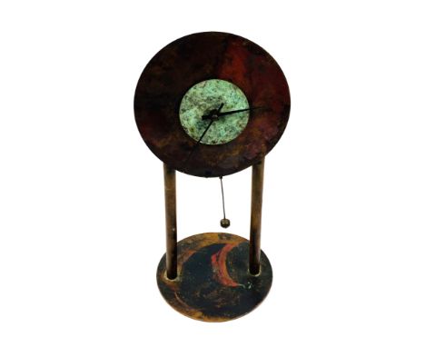 A 20th century minimalistic patinated copper mantle clock, 16.5cms base diameter x 35.5cms high. Estimate £15-40.