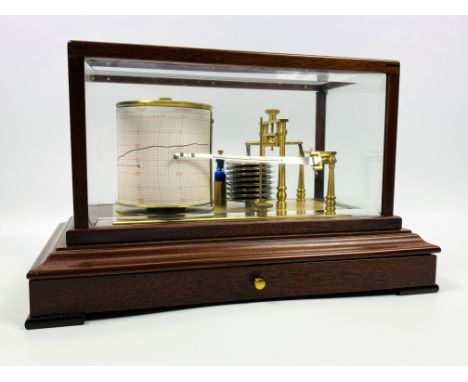 A contemporary mahogany and bevelled glass cased barograph by Comitti of London, complete with charts, 36cms wide x 22cms dee