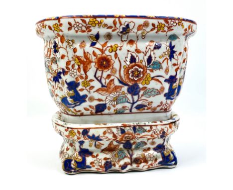 A 20th century ceramic Imari style planter on stand, decorated in typical palette throughout with character marks to the unde