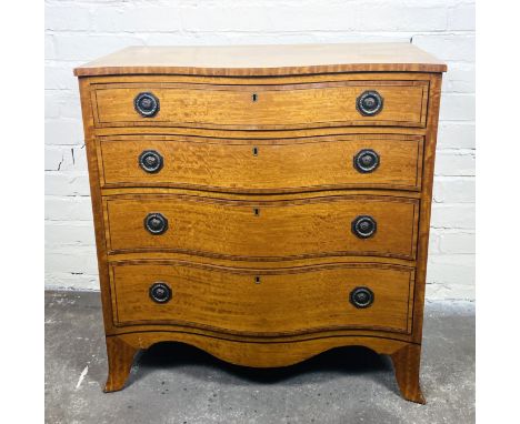 A small early 20th century satinwood serpentine chest of four graduated mahogany lined drawers with tulipwood inlaid decorati