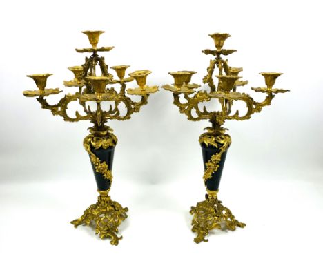A large pair of French Rococo style gilt ormolu five branch candelabra with serpentine central columns, 28cms wide x 28cms de