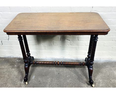 A late 19th century Victorian mahogany stretcher table with spiral decorated turned end supports with finials, and united by 