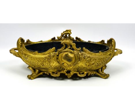 A 19th century French Rococo style twin handle gilt ormolu planter of oval design, well cast decoration throughout and comple