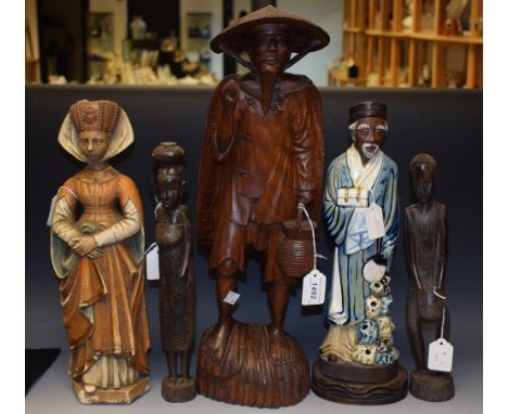 A Chinese carved figure of a fisherman carrying a basket, 55 cm in height; two carved African figures, male and female; a Cer