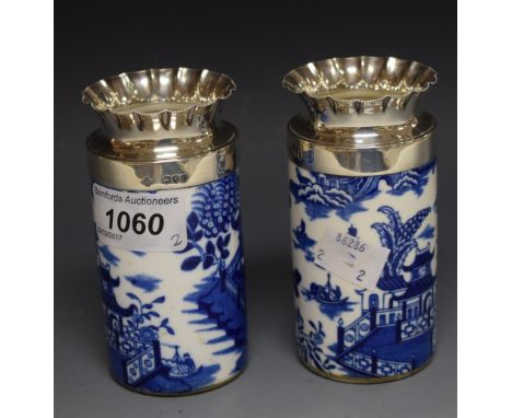 A pair of silver-mounted Royal Worcester vases, decorated in underglaze blue with pagoda and foliage, crimpled rim, 10cm high