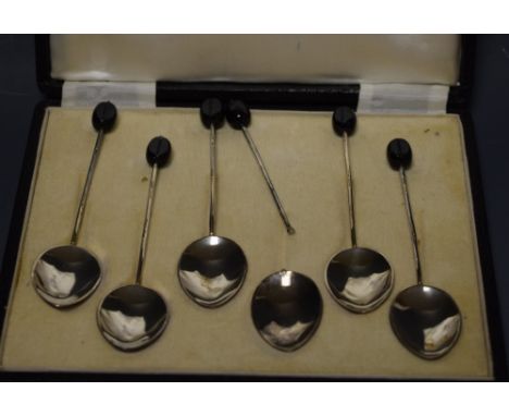 A boxed set of enamelled silver coffee spoons, rose and bow decoration, engine turned ground, coffee bean finials in Harrods 