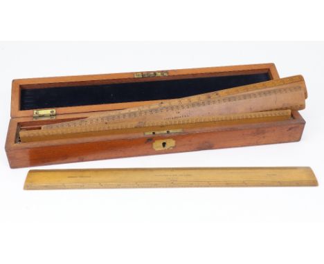 A late Victorian rectangular mahogany rulers box, the hinged top with a brass cartouche and enclosing divisions for six ruler