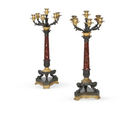 A PAIR OF EMPIRE REVIVAL BRONZE AND ORMOLU SIX LIGHT CANDELABRA FRENCH, LATE 19TH CENTURY Gilt metal mounts with stiff foliat
