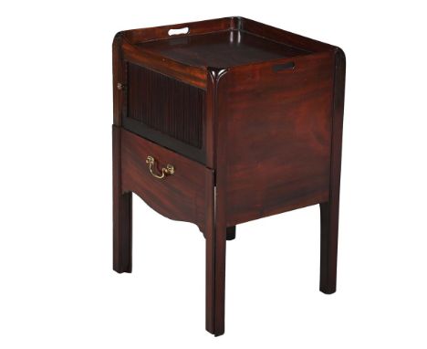 A GEORGE III MAHOGANY BEDSIDE NIGHT COMMODE  CIRCA 1780 With tambour front enclosing a compartment above a slide 75cm high, 5