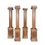 A SET OF FOUR FREESTANDING CARVED OAK IONIC COLUMNS, 20TH CENTURY