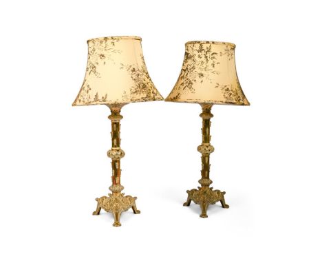 A PAIR OF POLISHED BRASS LAMPS IN CELTIC REVIVAL STYLE, 20TH CENTURY 90cm high (including shades), the bases 25cm x 22cm   Co