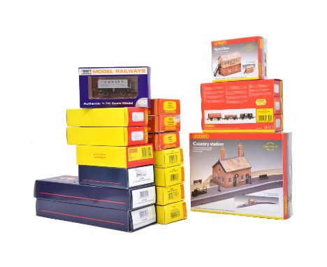Fifteen OO gauge model railway coaches and freight wagons, including Hornby, Bachmann and Dapol; two Hornby trackside buildin