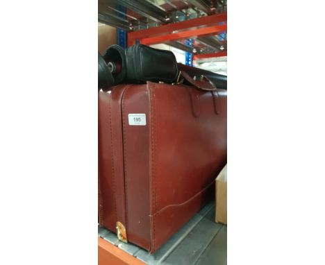 A cased snooker cue and a leather briefcase.&nbsp;Modern 2 piece cue, mesh pattern under laminated finish. No manufacturers n