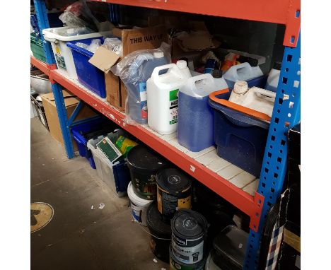 A shelf of car cleaning and maintenance products, and a floor space containing garden items eg fence paint, plant feed, house