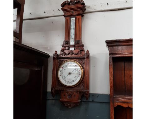 A Victorian walnut aneroid barometer. 