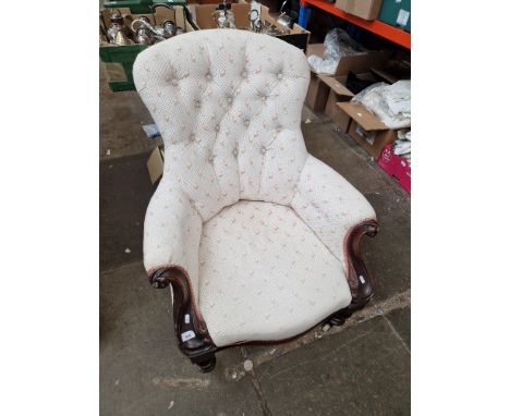 A Victorian mahogany framed button back armchair. 