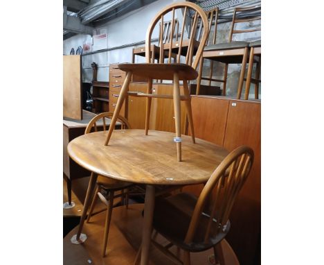 A 1960s Ercol light elm breakfast table (model 396) with four Ercol 'Windsor' chairs.