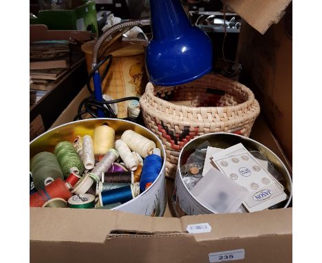 A box of sewing items including bobbins of thread, buttons, lamp, etc.