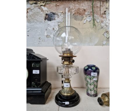A duplex glass oil lamp. Condition- some chips and imperfections to the ball shade, mostly to the base, the most obvious one 