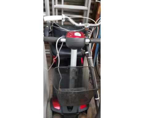 A mobility scooter with charger, as found (not running &amp; wheel lock jammed)