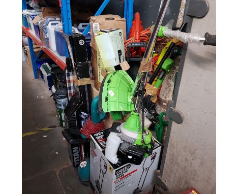 A large collection of powered garden tools including electric tiller, petrol brush cutter, petrol extended multi tool, strimm
