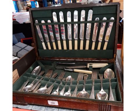 A 52 piece silver plated canteen of cutlery by F Cobb, Sheffield in Art Deco oak case.