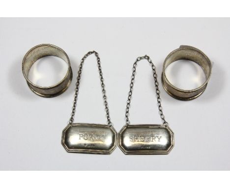 A pair of silver napkin rings and 2 hallmarked silver decanter labels