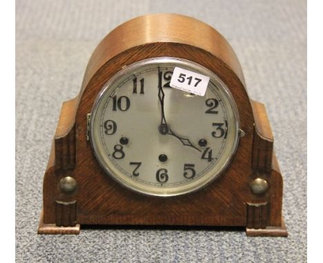 An oak chiming mantle clock