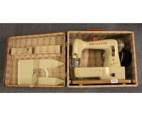 A vintage cased Helvetia electric sewing machine