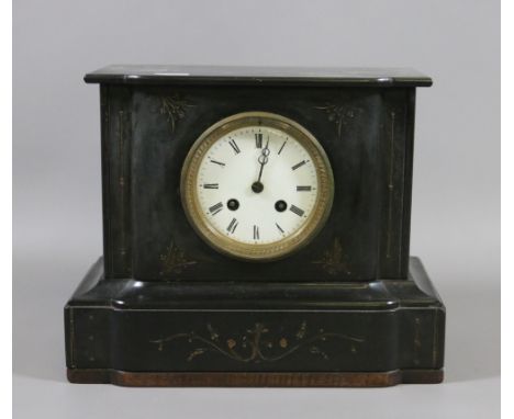 A Victorian slate cased mantel clock with white enamel dial Roman numeral markers and chiming on a gong with key.
