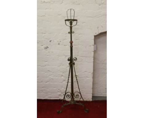An Art Nouveau brass and copper rise and fall standard lamp.