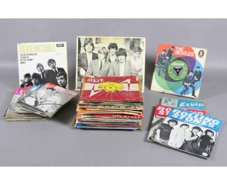 A collection of pop memorabilia to include Elvis and Rolling Stones monthly books, along with a collection of singles to incl