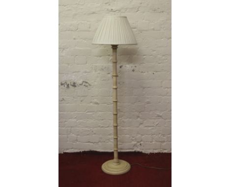 A turned and painted standard lamp and shade.