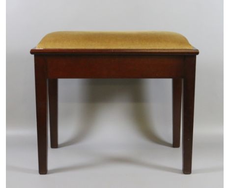 A mahogany piano stool with under seat storage and raised on tapering supports.