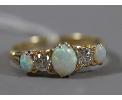 A ladies 18ct gold opal and diamond five stone ring, 3.18 grams.