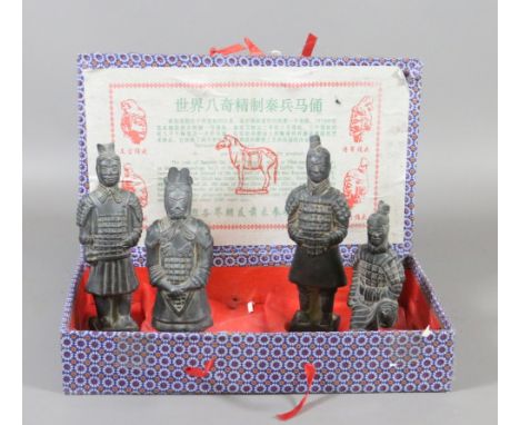 A Chinese silk mounted box containing souvenir figures of the Terracotta Army.