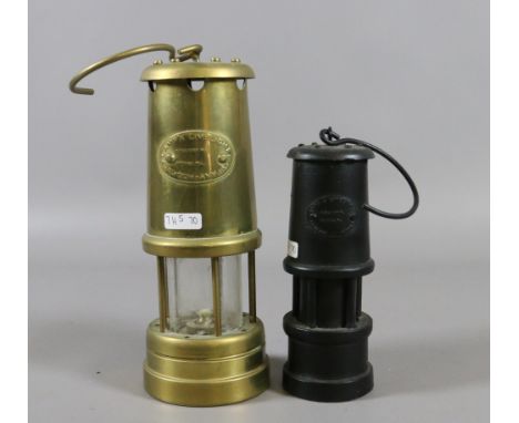 A brass Limelight Company Hockley miners lamp along with a smaller carved coal miners lamp.