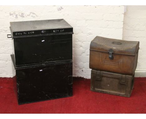 A dome top tin trunk and an ammunition box along with two metal storage trunks.