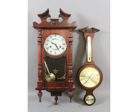 A mahogany cased 31 day wall clock chiming on a gong along with a wall barometer.