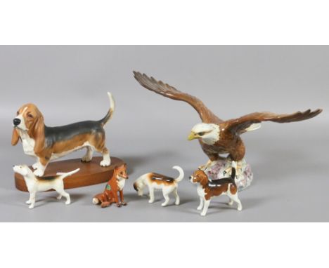 A collection of Beswick models. A bisque basset hound, an eagle, a seated fox and three beagles.