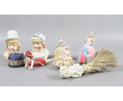 A collection of miniature porcelain half dolls along with two bisque half dolls.