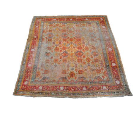 An Ushak carpet, the burnt orange field decorated with an overall design of stylised foliate motifs, the red border within or