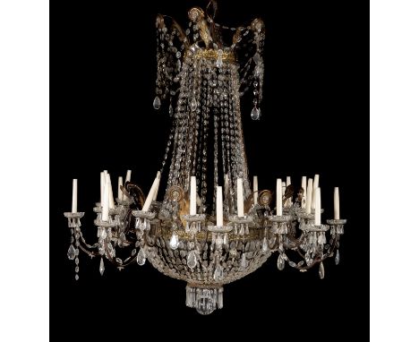 A pair of Continental clear glass and gilt metal mounted twenty-four light chandeliers in early 19th century taste, loosely o