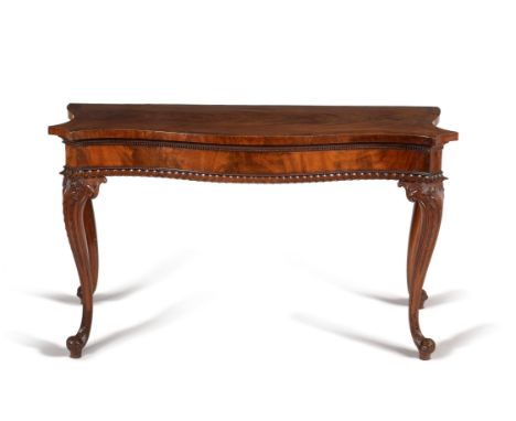 A George III mahogany serpentine serving table, circa 1760, attributed to William Vile,  the figured top with triple slender 