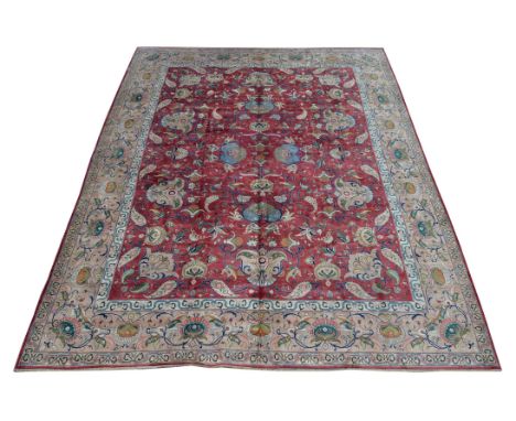 A Tabriz carpet, signed Javan Amir Khiz, the madder field decorated with an overall design incorporating palmettes and stylis