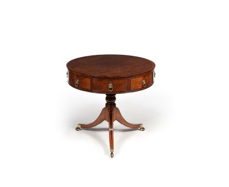 A Regency mahogany and 'plum pudding' mahogany drum library or 'rent' table, circa 1820, in the manner of Gillows, incorporat