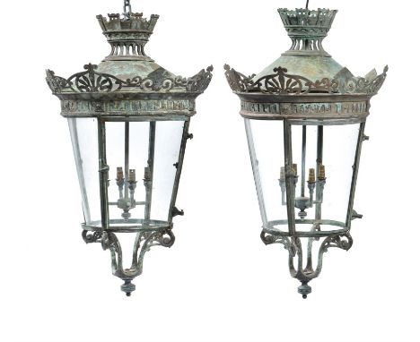 A pair of French verdigris patinated copper and glazed hanging lanterns, late 19th/early 20th century, the domed tops cast wi