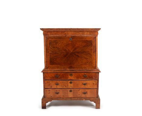 A Queen Anne walnut and feather banded escritoire, circa 1710, the moulded cornice above a cushion moulded drawer, the fall f